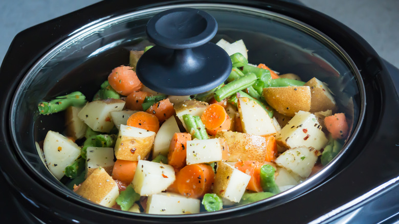 Slow cooker with veggies inside