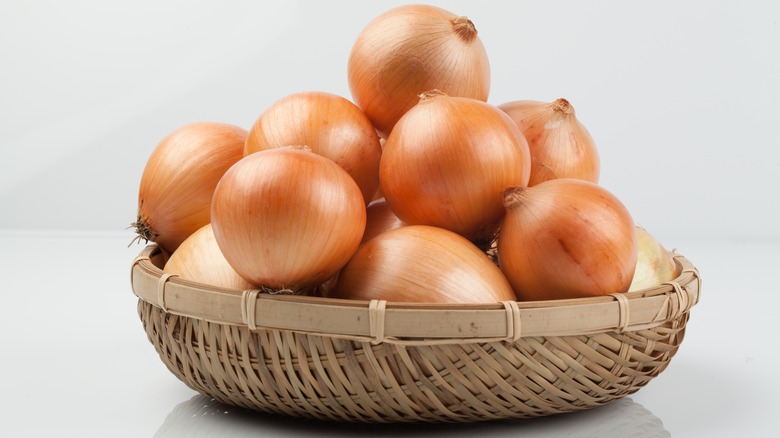 Woven basket of yellow onions