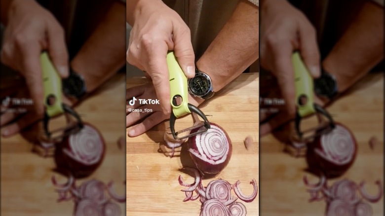 slicing red onion with vegetable peeler