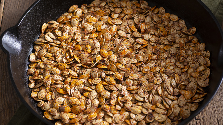 Roasted pumpkin seeds in skillet