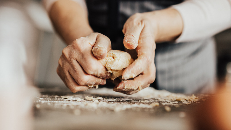 Person kneading biscuit dough