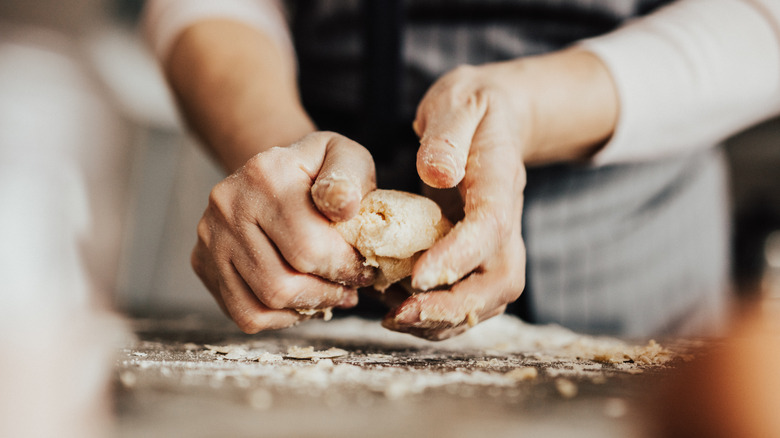 hands kneading dough