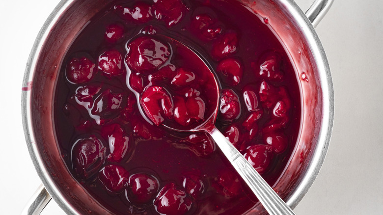 Preparing a cherry glaze in a pan