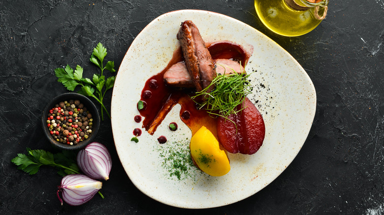 Sliced duck with pear and a cherry sauce