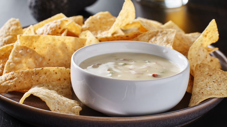 A bowl of queso with chips