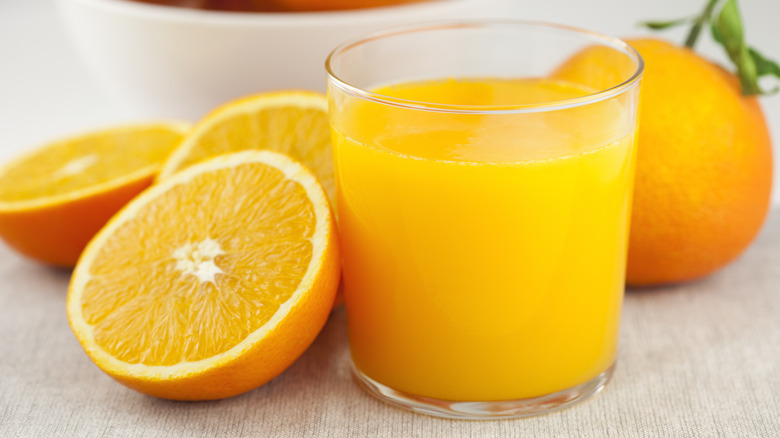 Glass of orange juice with oranges