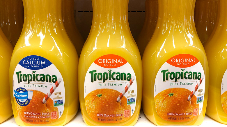 Bottles of orange juice in refrigerator