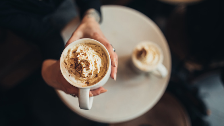 Person holding latte