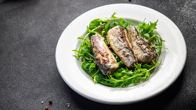 Canned sardines on bed of rocket