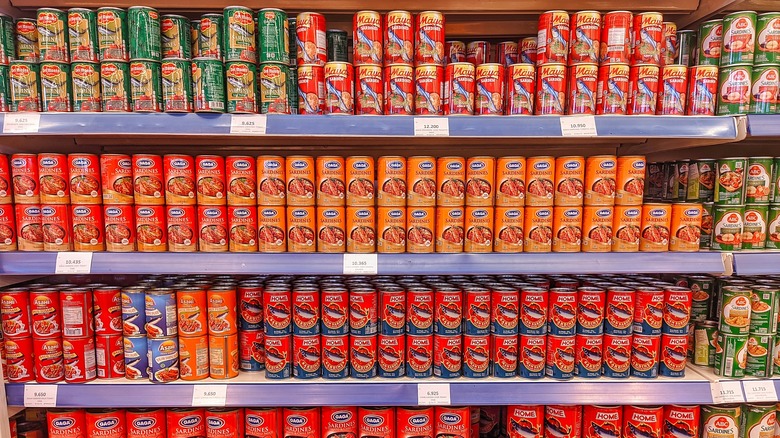 Supermarket shelf with cans of sardines