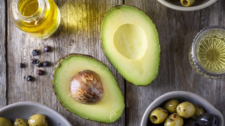 halved avocado on wooden table