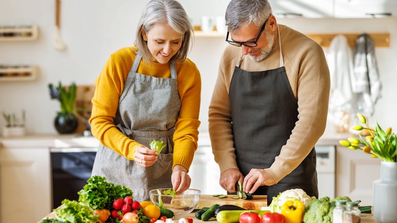 couple cutting vegetables