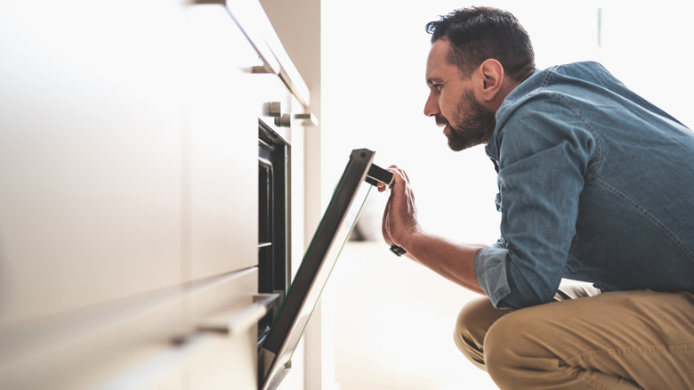 man opening oven door