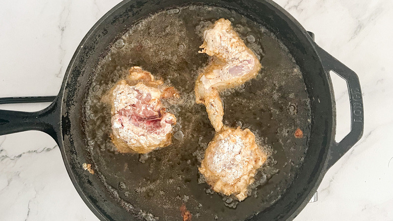 chicken frying in skillet