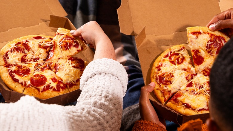 people eating individual pizzas from Schlotzsky's