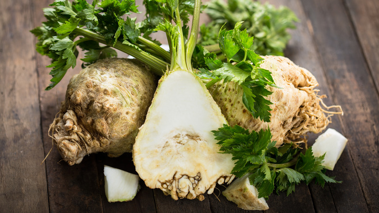 Halved celery root on wooden background