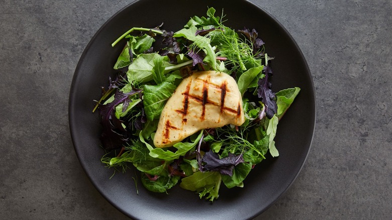 Good Meat cultivated chicken breast over greens