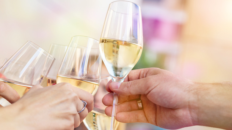 people toasting with prosecco glasses