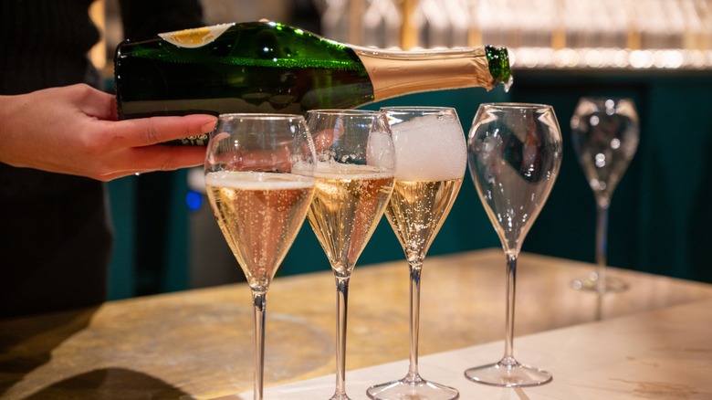 Champagne being poured into a series of glasses