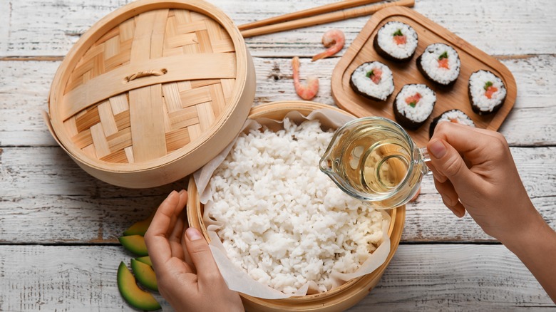 rice vinegar being added to rice for sushi