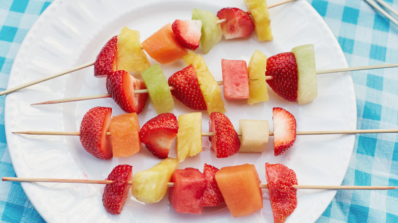 Fruit skewers on white plate