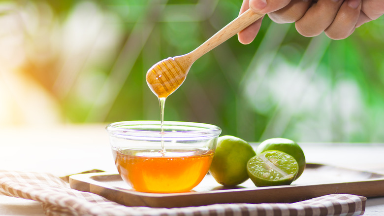 Bowl of honey with limes