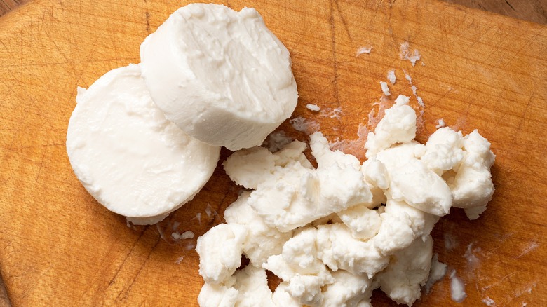 Two sliced rounds and crumbles of goat cheese