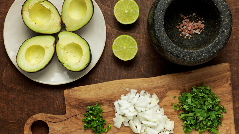 sliced avocado with chiles, cilantro, and onions