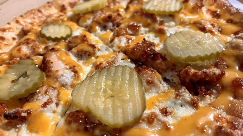 closeup of pickles on pizza