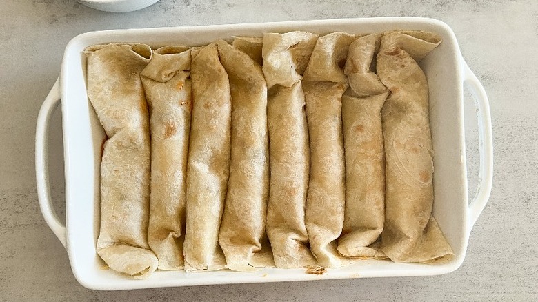 rolled up tortillas in baking dish