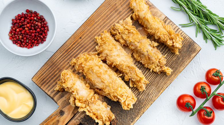 Chicken tenders on cutting board