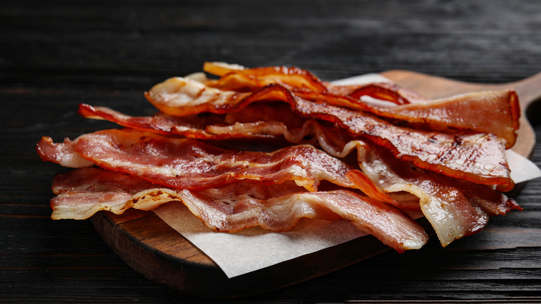 bacon rashers on wooden board