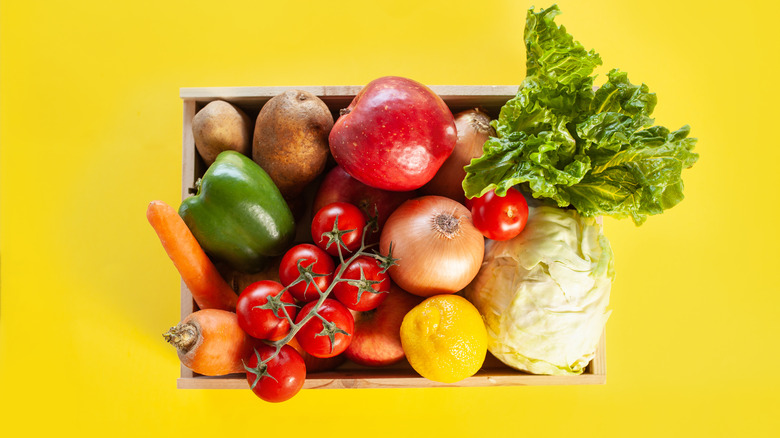 Box of produce against yellow background