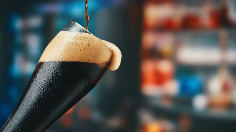 dark beer poured into glass