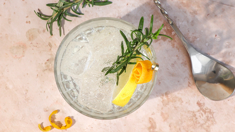 An aerial view of a gin and tonic with rosemary