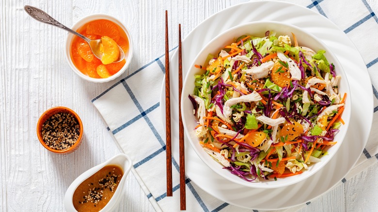 Chopsticks next to salad bowl