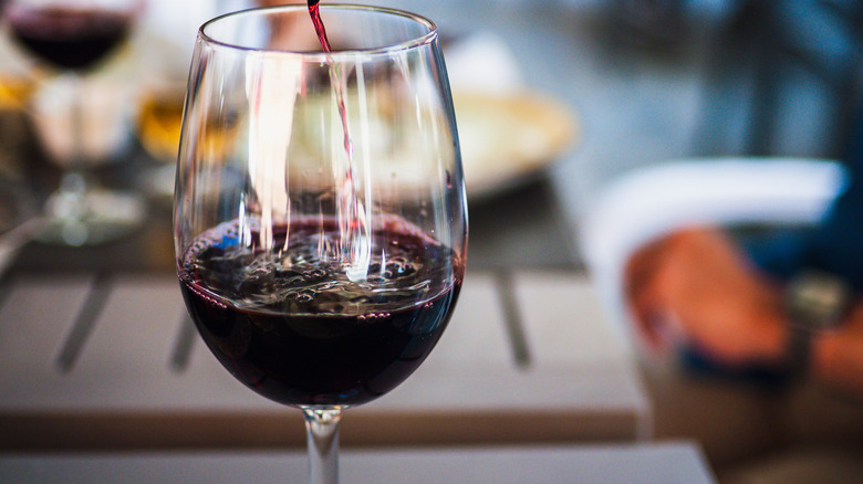 Pouring glass of Bordeaux wine