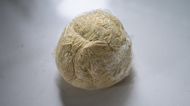 cheese ball wrapped in plastic
