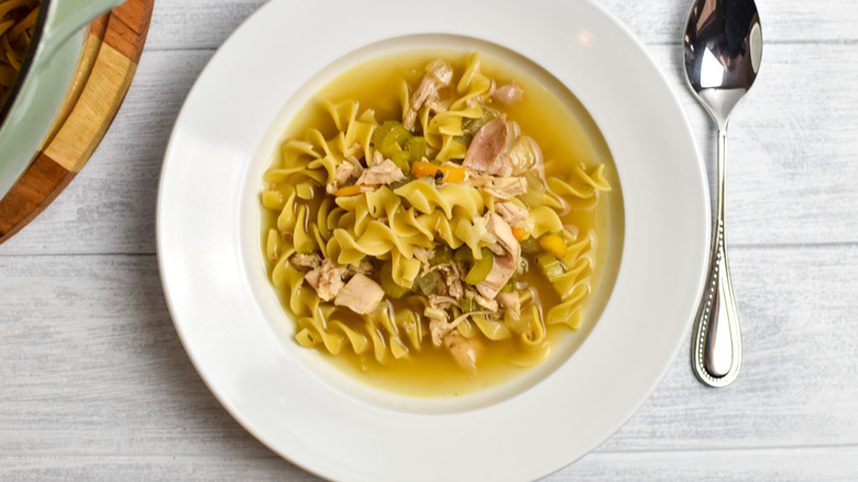 classic chicken noodle soup in bowl 