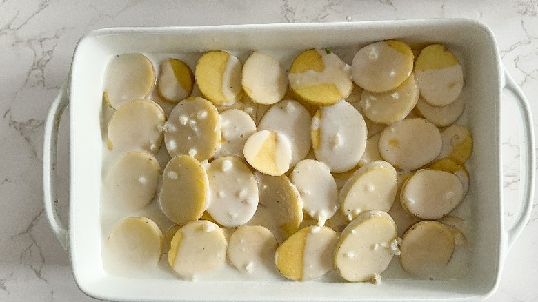 unbaked scalloped potatoes in baking dish