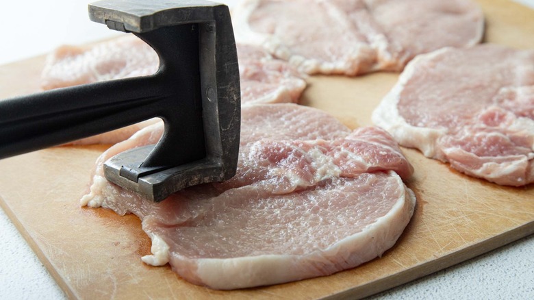 meat mallet tenderizing a pork chop