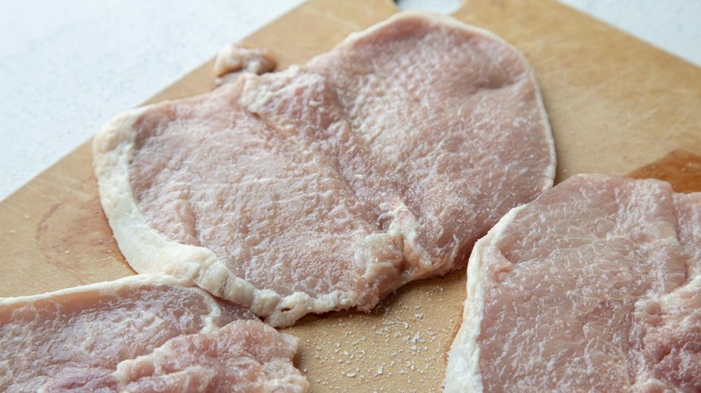 raw pork chops with salt