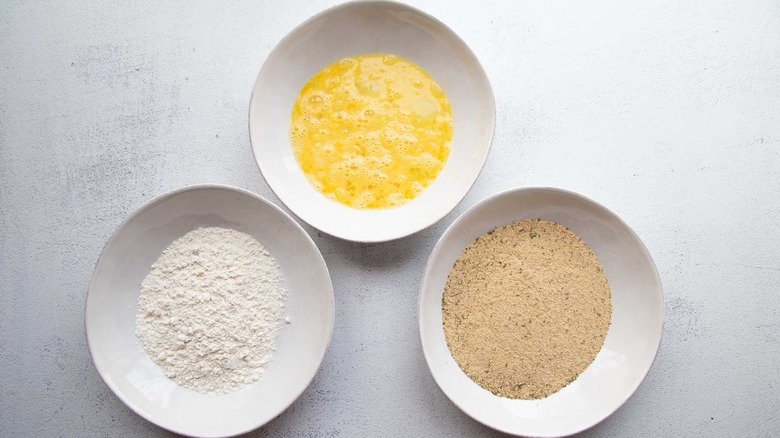 bowl of flour, bowl of eggs, bowl of breadcrumbs