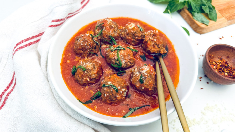 meatballs in tomato sauce on white plate