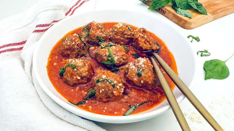 bowl of meatballs with golden silverware