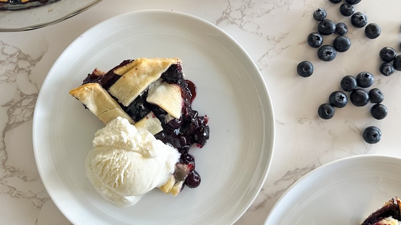 slice of lattice top blueberry pie