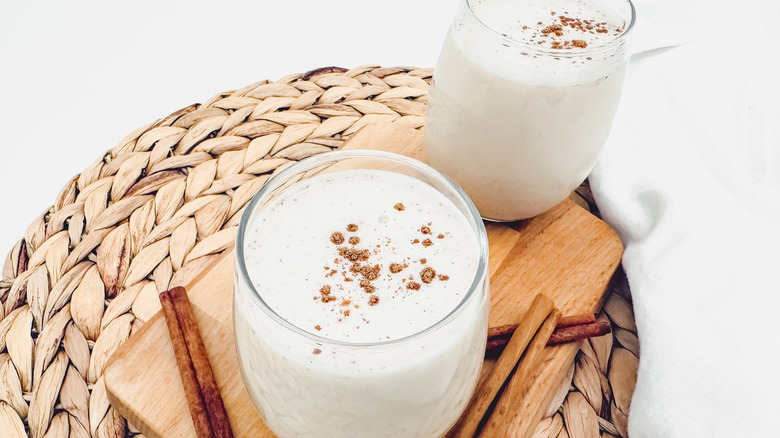 horchata glasses next to cinnamon sticks