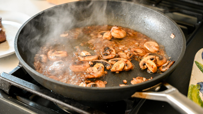mushrooms in pan with cognac 