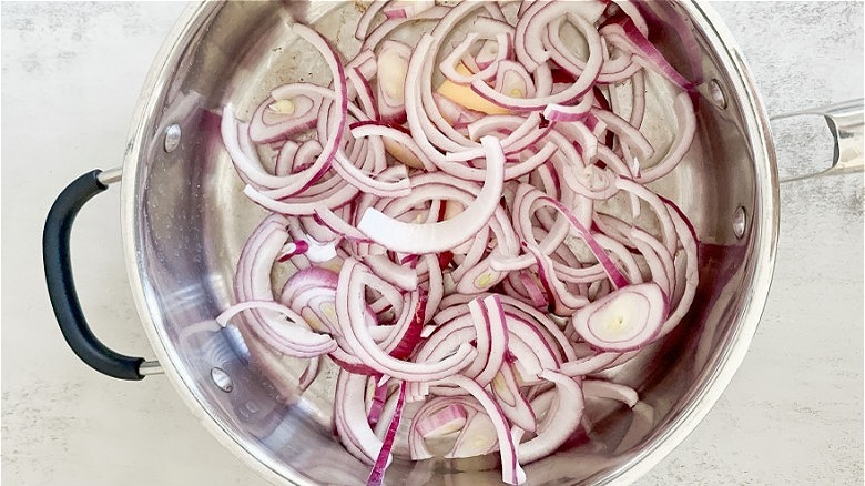 sliced onions in a skillet