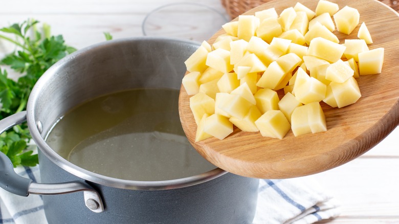 Diced potatoes added to a pot